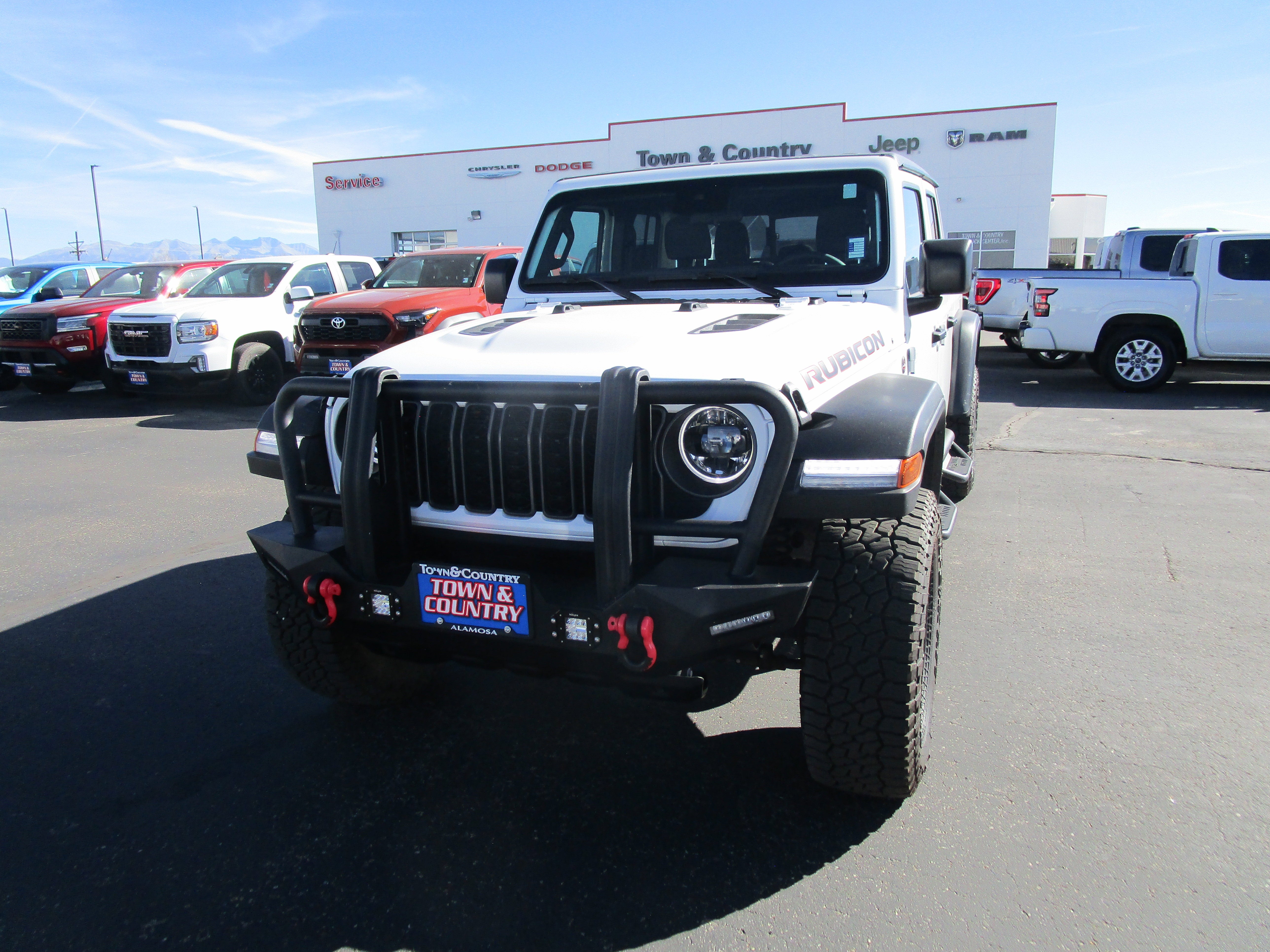 2024 Jeep Gladiator Rubicon in Bright White Clear Coat — front three-quarter view