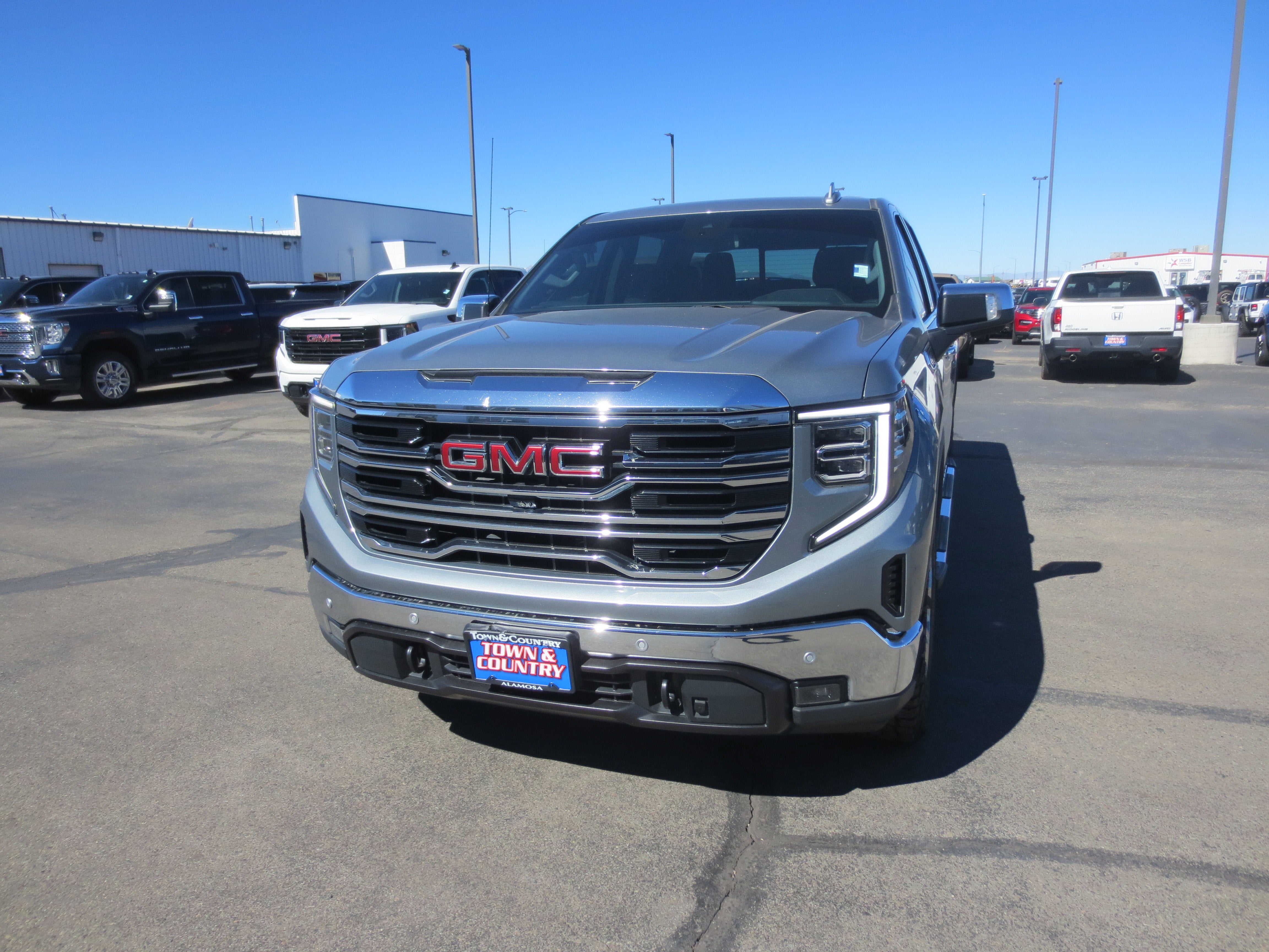 2023 GMC Sierra 1500 SLT in Sterling Metallic — front three-quarter view