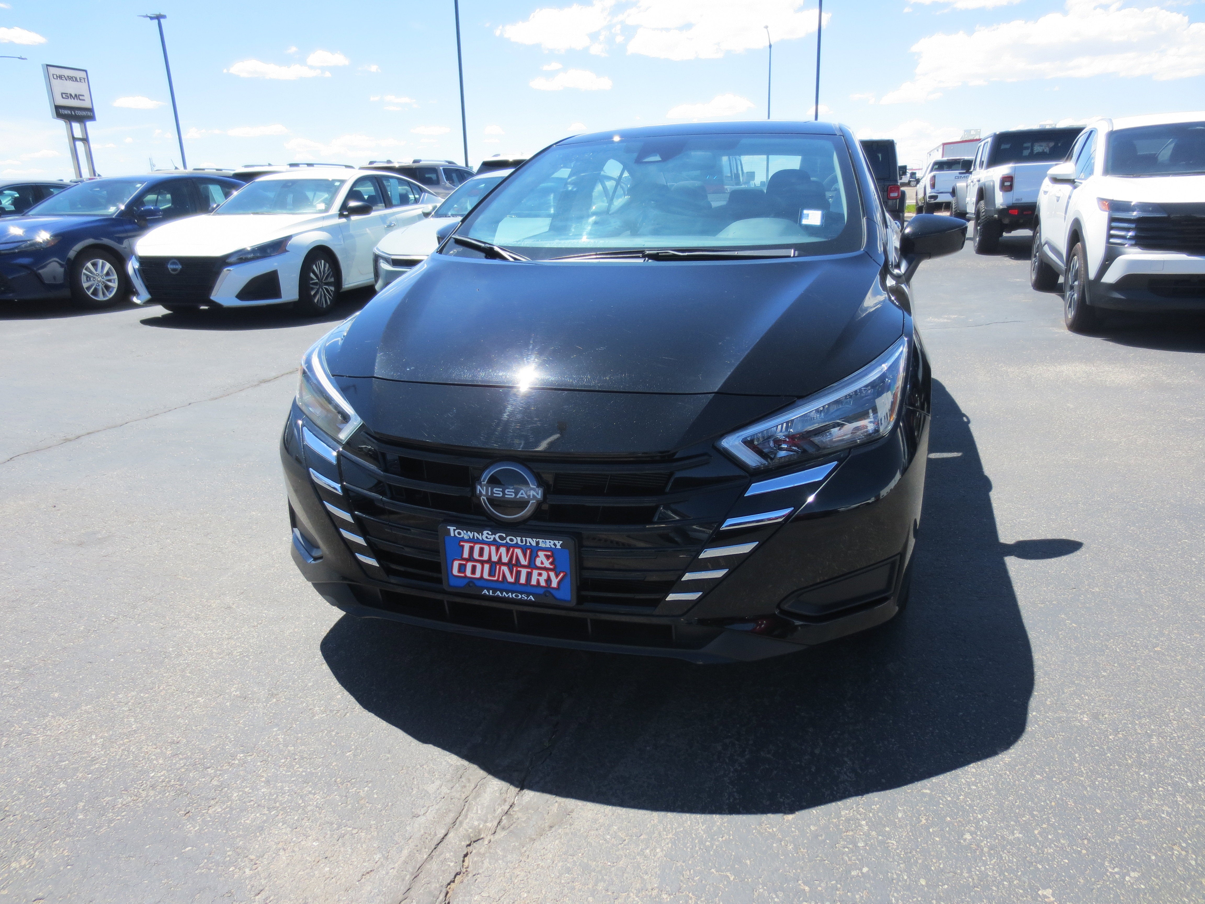 2025 Nissan Versa SV in Black — front three-quarter view