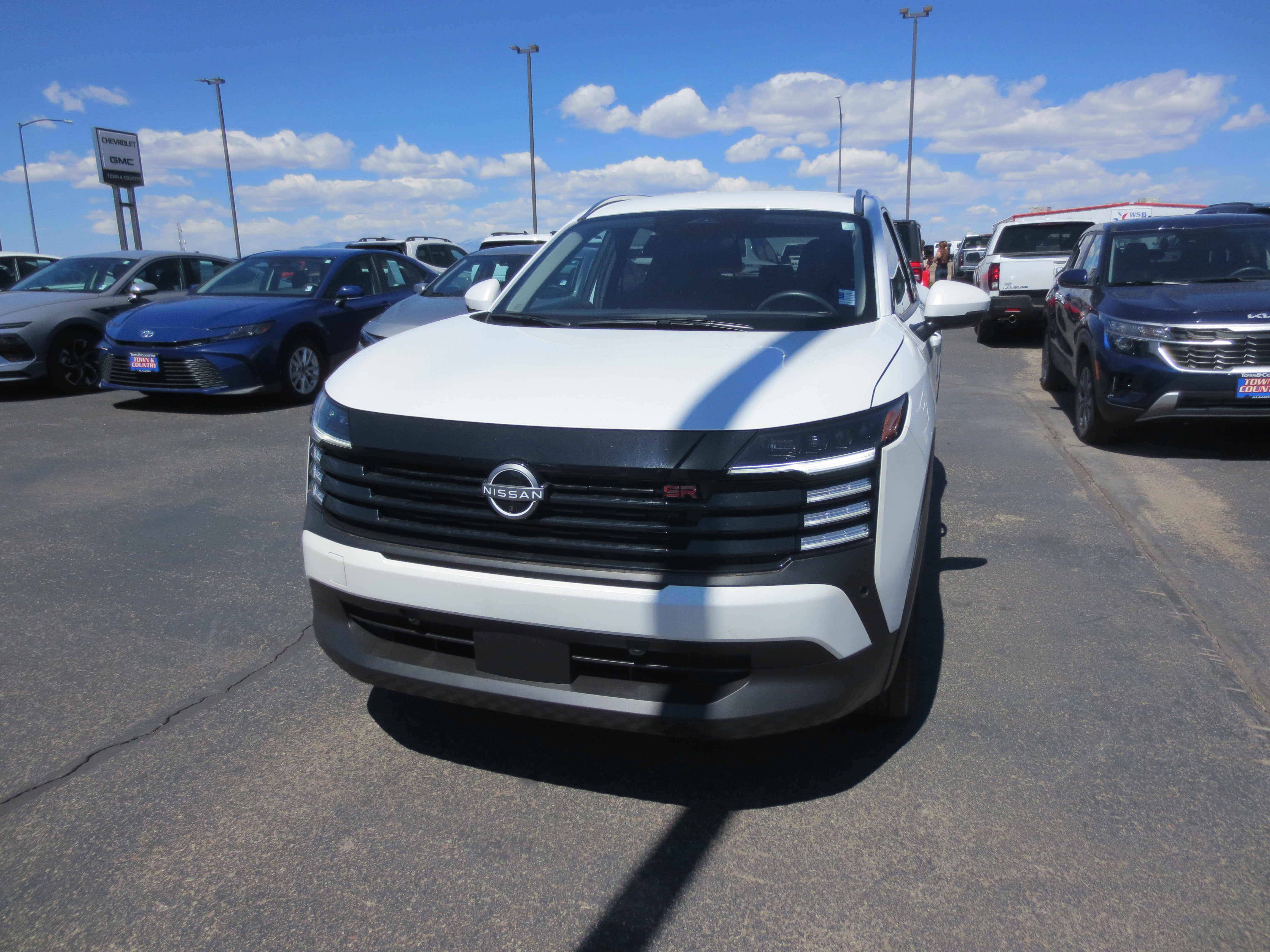 2025 Nissan Kicks SR in White — front three-quarter view