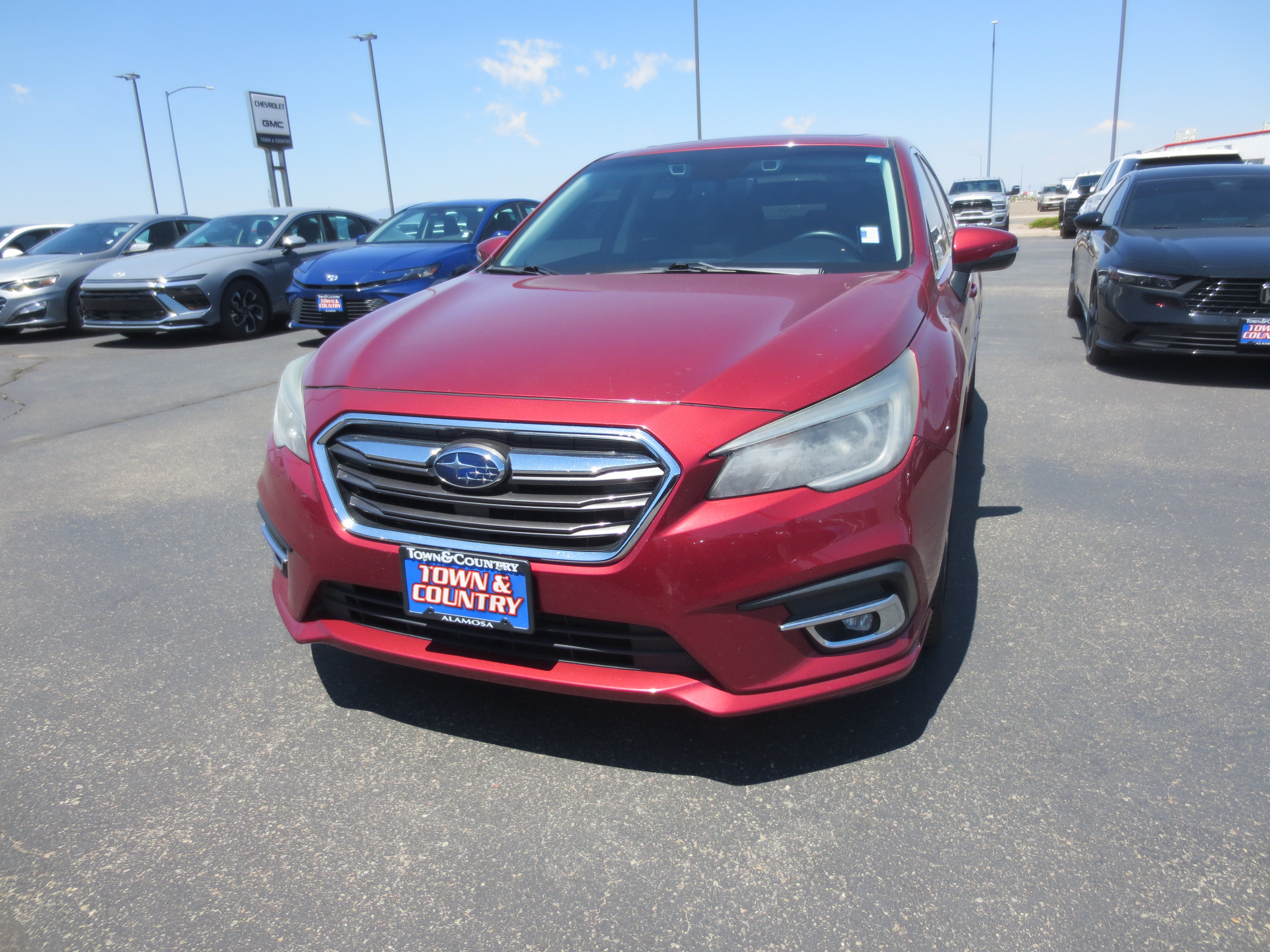 2018 Subaru Legacy Limited in Red — front three-quarter view